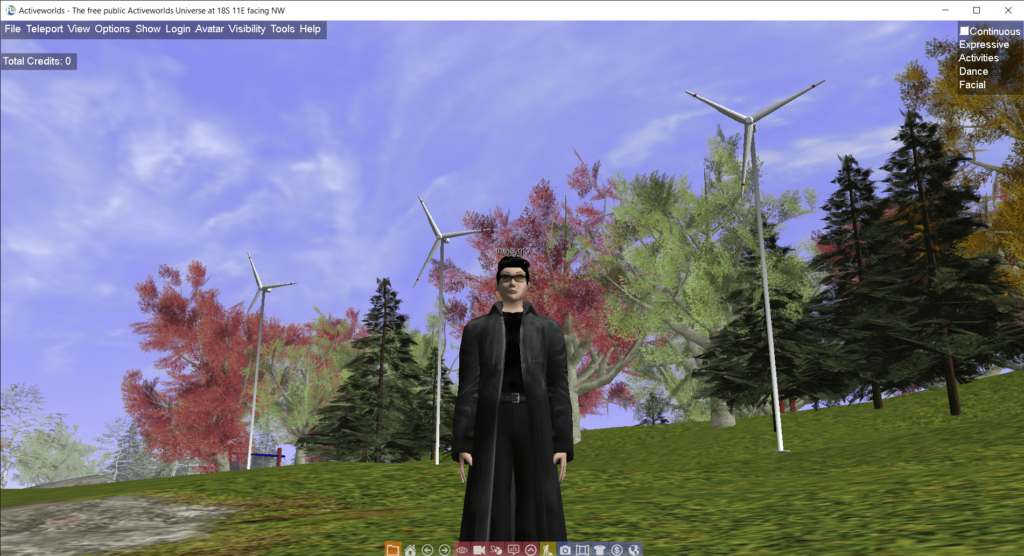 Screenshot of Activeworlds showing an avatar in a long black coat standing on a grassy hill with trees and wind turbines. The window title reads: Activeworlds - The free public Activeworlds Universe at 18S 11E facing NW.