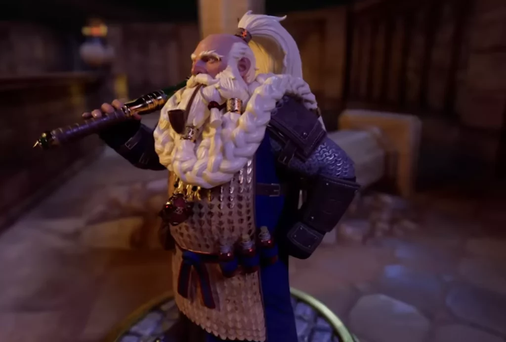 Detailed miniature of a dwarf with a massive braided white beard and ponytail, wearing scale mail and holding a long ornate pipe.