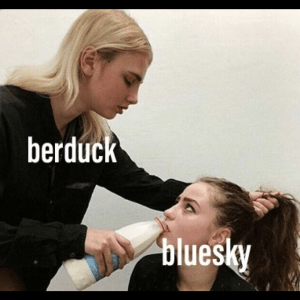A woman labeled berduck forces milk from a bottle into the mouth of another woman labeled bluesky while pulling her hair back.