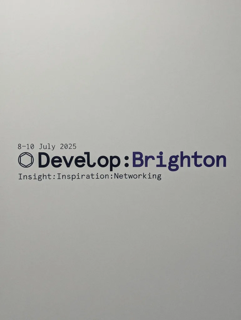 Develop:Brighton logo on a grey wall with the dates 8-10 July 2025 and tagline Insight:Inspiration:Networking.